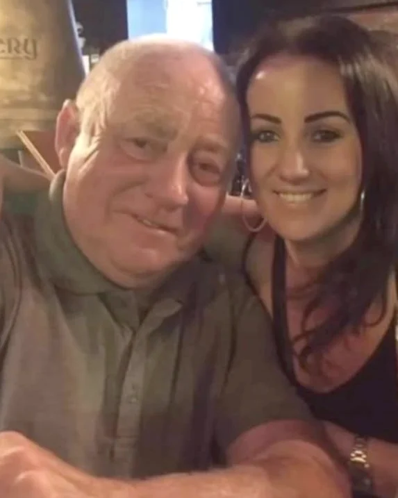 Lynne with her Dad, her arm around his shoulder, both smiling.